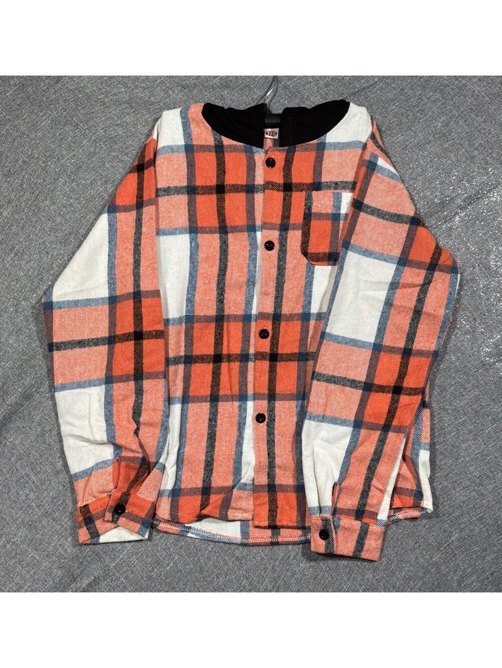 orange and white plaid button-down shirt featuring a contrasting black hood.